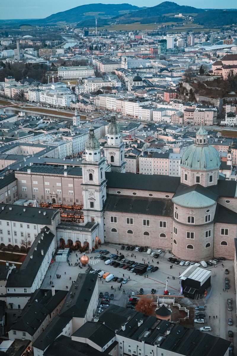 Stunning aerial view of Salzburg Cathedral amidst the cityscape, capturing urban vibrancy.