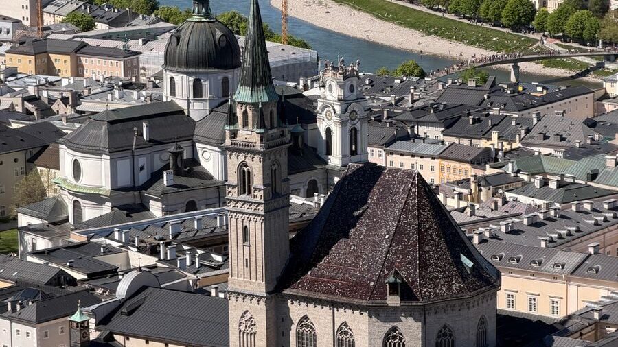 A panoramic aerial view of Salzburg, Austria, highlighting the majestic Salzburg Cathedral and picturesque surroundings.