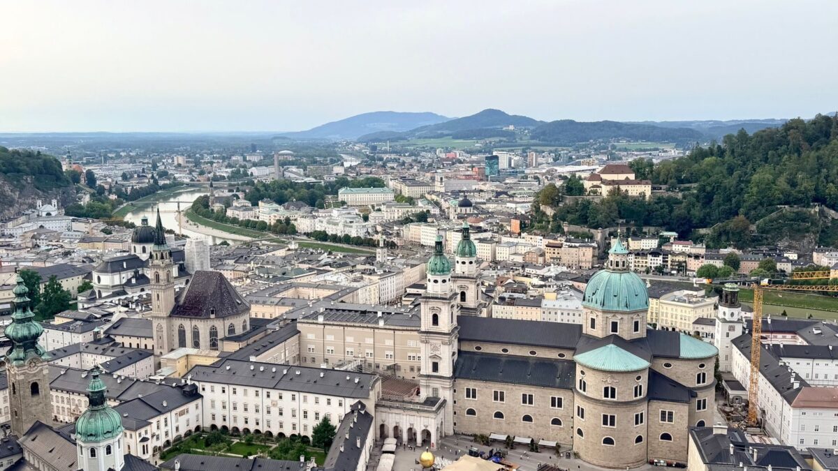 Photo by Catherine Kozdoba Stunning aerial view of Salzburg, Austria, showcasing historic architecture and scenic landscapes.