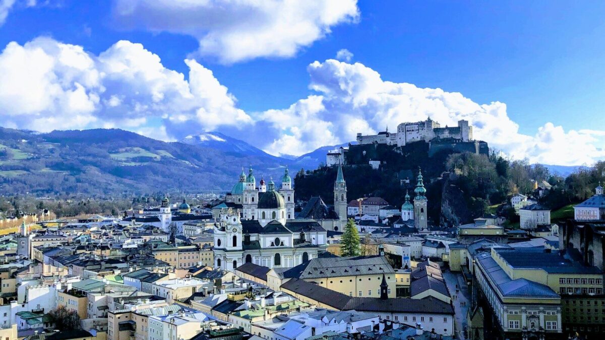 city buildings under blue sky and white clouds during daytime