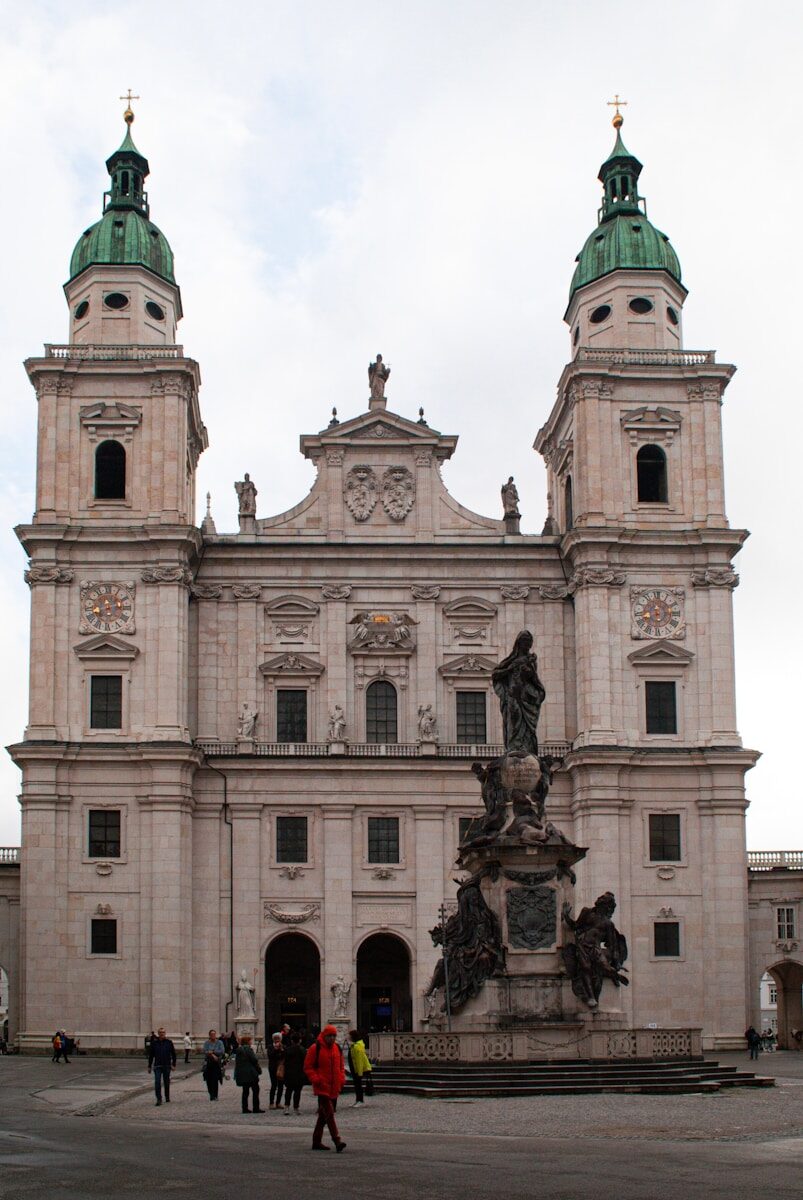 a large stone building with a statue in front of it