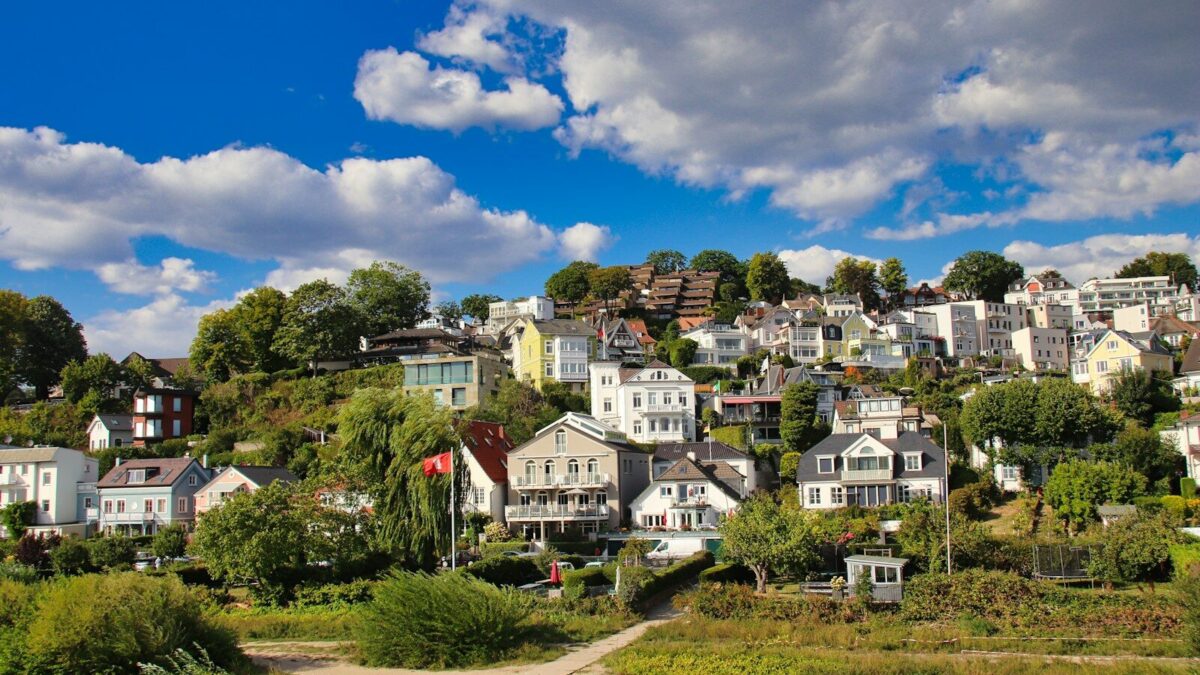 Photo by Alain ROUILLER a group of houses sitting on top of a lush green hillside