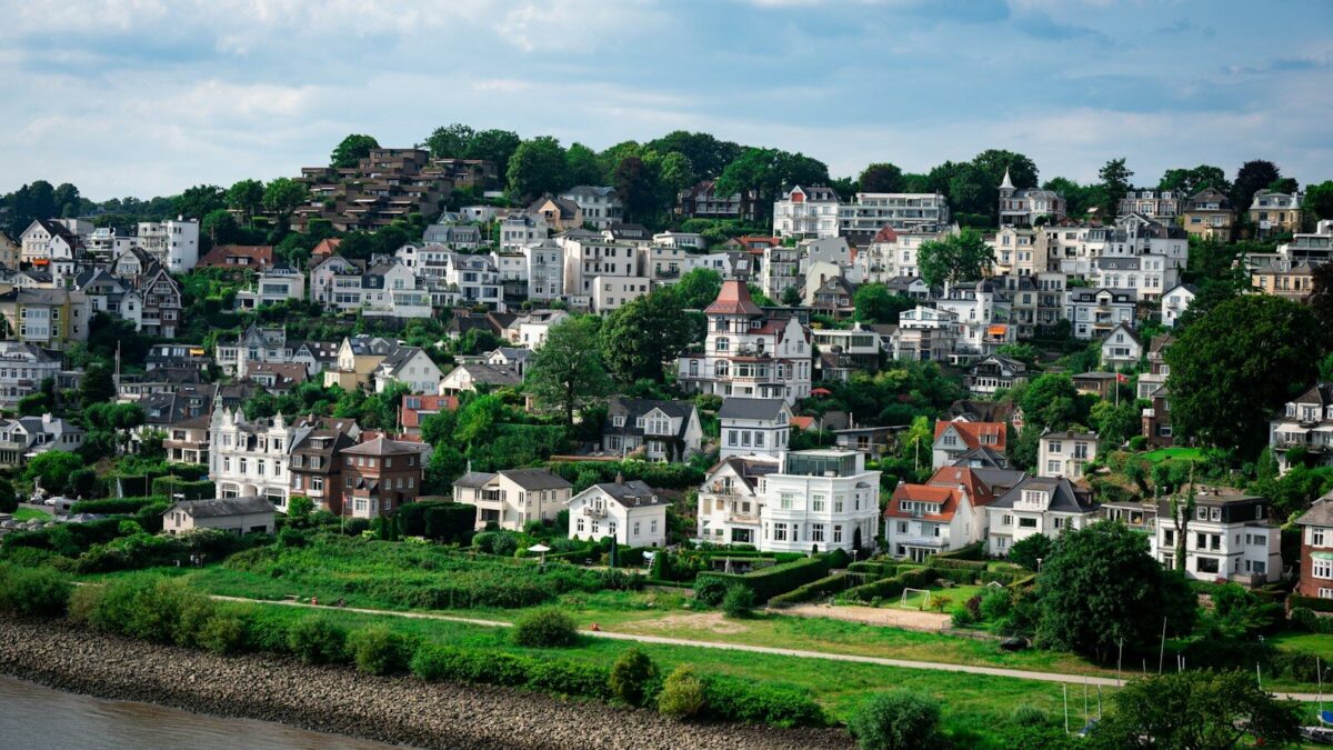Photo by Julia Taubitz Hillside neighborhood with river and green landscape